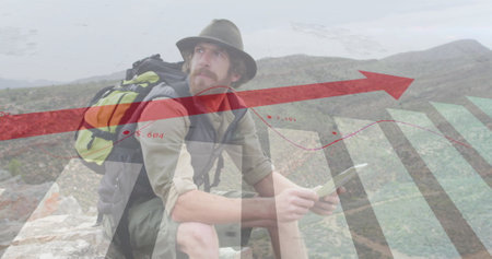 Image of financial data processing over caucasian man reading map in mountains. Global travel, finances, computing and digital interface concept digitally generated image.の写真素材