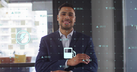 Image of ecology icons and data processing over biracial casual businessman smiling in office....