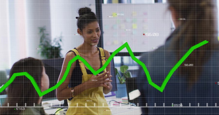 Image of diagrams and data processing over diverse colleagues discussing work in office. Technology, business and digital interface concept digitally generated image.の写真素材