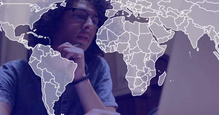 Image of world map and data processing over caucasian businessman using laptop in office. Global...