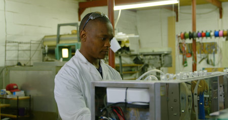 Worker working in glass factory. Attentive worker