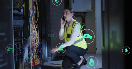 Image of eco icons and data processing over caucasian businesswoman by computer servers. Global...