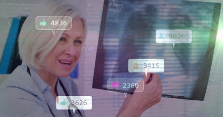 Social media engagement image over smiling doctor pointing at screen. Healthcare, technology, digital, interaction, communication, onlineの写真素材