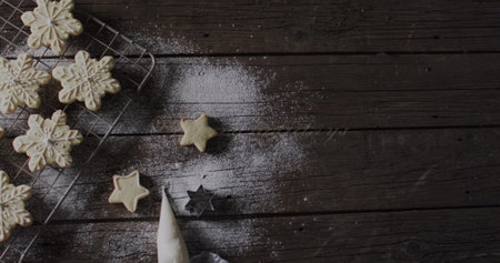 Star-shaped cookies and cutters on a dark wooden table, with copy space. Baking at home brings a cozy atmosphere and the joy of homemade treats.の写真素材