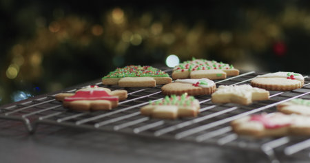 Freshly baked Christmas cookies cool on a wire rack, with copy space. Holiday baking traditions come...