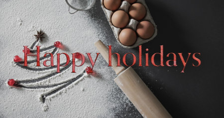 Happy holidays text in red over christmas tree drawn in flour, eggs and rolling pin. Christmas, tradition, greetings and celebration digitally generated image.の写真素材