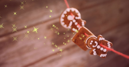 Image of stars over cookies at christmas. Christmas, tradition and digital interface concept digitally generated image.の写真素材