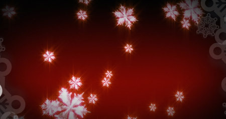 Image of glowing snowflakes falling against red background with copy space. Christmas festivity and celebration conceptの写真素材