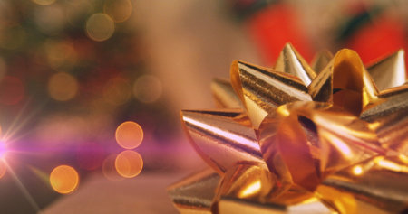 Image of glowing lights moving over flickering fairy lights and gold christmas decorations. christmas, tradition and celebration concept digitally generated image.の写真素材