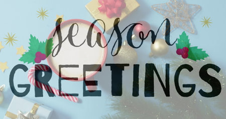 Image of seasons greetings text over christmas decorations. Christmas, celebration and digital interface concept digitally generated image.の写真素材