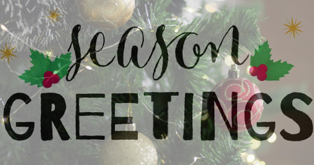 Image of christmas greetings text over christmas tree and decorations. Christmas, festivity, celebration and tradition concept digitally generated image.の写真素材