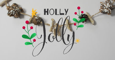 Image of happy jolly text over christmas decorations. Christmas, tradition and celebration concept digitally generated image.の写真素材