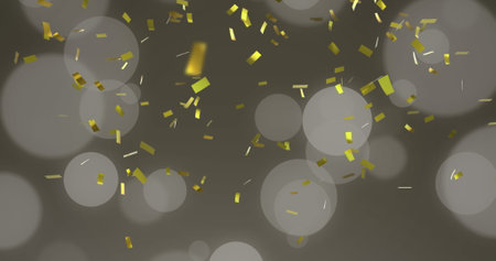 Image of gold christmas confetti falling with spots of light on grey background. Christmas, winter, festivity, tradition and celebration concept digitally generated image.の写真素材
