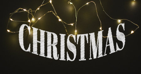 Image of christmas greetings text over christmas fairy lights. Christmas, festivity, tradition and celebration concept digitally generated image.の写真素材