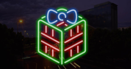Image of christmas present over cityscape at night. christmas, tradition and celebration concept digitally generated image.の写真素材