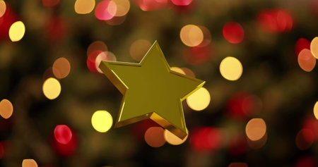 Image of christmas gold star over flickering christmas tree lights in background. Christmas, festivity, celebration and tradition concept digitally generated image.の写真素材