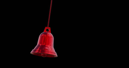Image of red bell christmas bauble decoration over black background. Christmas, tradition and celebration concept digitally generated image.の写真素材