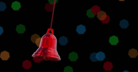 Image of christmas red bell bauble decoration over black background. Christmas, tradition and celebration concept digitally generated image.の写真素材