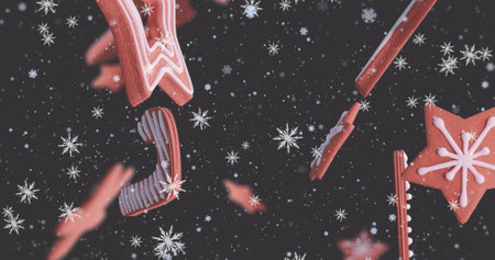 Image of christmas gingerbread cookies over snowflakes falling. Christmas, festivity, tradition and celebration concept digitally generated image.の写真素材