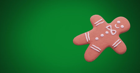 Image of christmas gingerbread cookie with copy space on green background. Christmas, festivity, tradition and celebration concept digitally generated image.の写真素材