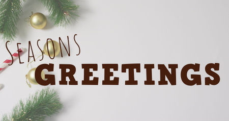 Image of christmas greetings text over christmas decorations. Christmas, festivity, celebration and tradition concept digitally generated image.の写真素材