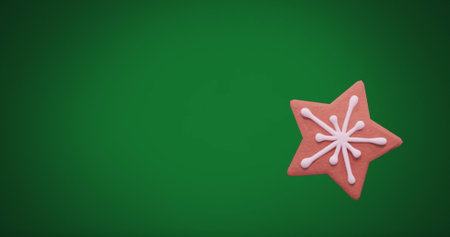 Image of christmas star gingerbread cookie with copy space on green background. Christmas, festivity, tradition and celebration concept digitally generated image.の写真素材