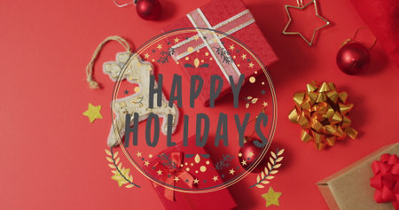 Image of happy holidays text over christmas decorations. Christmas, celebration and digital interface concept digitally generated image.の写真素材