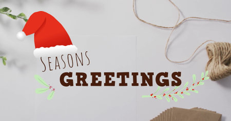 Image of seasons greetings text over christmas decorations. Christmas, festivity, celebration and tradition concept digitally generated image.の写真素材