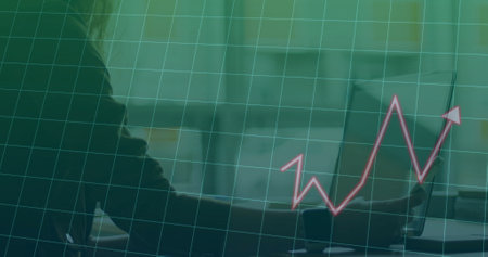 Image of arrow and diagrams over caucasian businesswoman using smartphone. Global business and digital interface concept digitally generated image.の写真素材