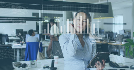 Analyzing data on tablet, businesswoman with graphs and charts image over office. analytics,...