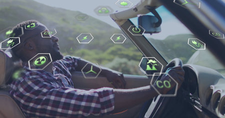 Driving convertible, man surrounded by eco-friendly technology image. innovation, green energy, sustainability, future, smart devices, environmentの写真素材