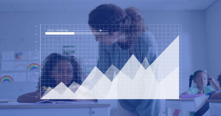 Image of graph processing data over diverse female teacher and schoolgirl talking in classroom. Education, learning, connection, digital interface and communication, digitally generated image.の写真素材