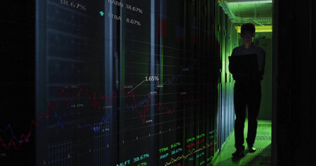 Image of data processing over asian male it engineer by computer servers. Global finance, business, connections, computing and data processing concept digitally generated image.の写真素材