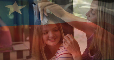 Image of flag of chile over caucasian mother and daughter brushing hair. Patriotism, lifestyle and...