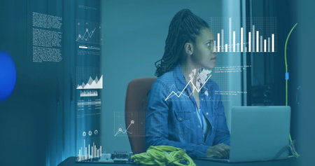 Image of diagrams and data processing over biracial female worker in server room. Technology and digital interface concept digitally generated image.の写真素材