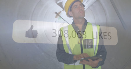 Construction worker using tablet, social media likes image over tunnel background. infrastructure,...