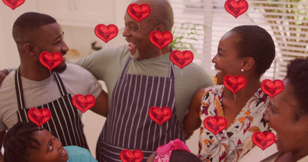 Red hearts image over family cooking together in kitchen. togetherness, love, bonding, home, meal...