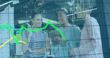 Image of data processing and diagrams over diverse female colleagues discussing work. Business, teamwork and digital interface concept digitally generated image.の写真素材