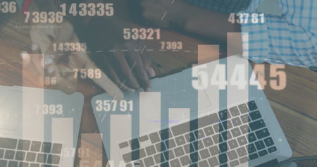 Image of graph and data processing over hands of diverse colleagues using laptops. Connection, data, business, processing, digital interface and communication, digitally generated image.の写真素材