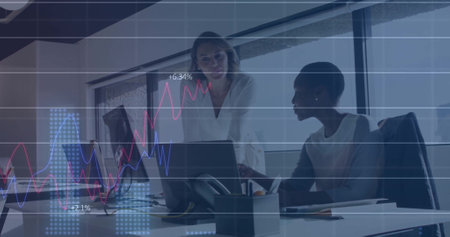 Image of data processing and diagrams over diverse businesswomen talking. Global business and digital interface concept digitally generated image.の写真素材