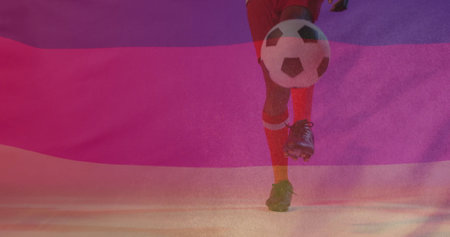 Image of flag of germany over african american male football player with ball. Sports, competition and active lifestyle concept digitally generated image.の写真素材