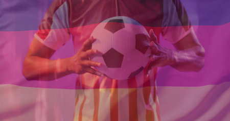 Image of flag of germany over african american male football player with ball. Sports, competition and active lifestyle concept digitally generated image.の写真素材