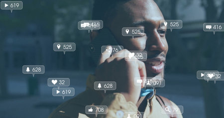 Image of social media notifications over happy african american man talking on smartphone. Digital...