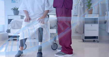 Image of dna over diverse male doctor and senior female patient with prosthetic leg. consultation, disability, digital interface, hospital and healthcare, digitally generated image.の写真素材