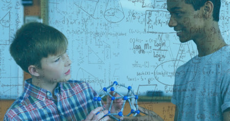 Examining molecular model, students with mathematical equations image over classroom background....