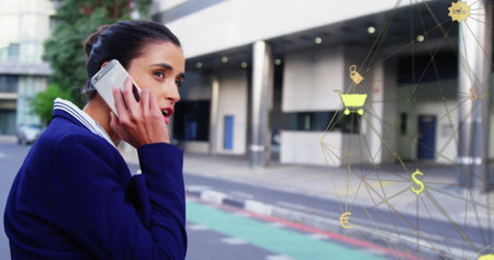 Image of connections with shopping icons over biracial businesswoman using smartphone. Global...
