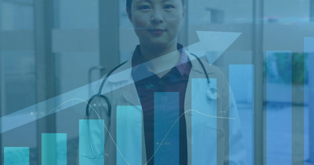 Image of financial data processing over asian female doctor in hospital. Global medicine, healthcare...
