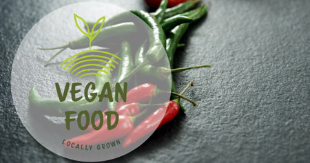 Vegan food logo image over fresh green and red chili peppers. organic, health, spicy, vegetarian,...