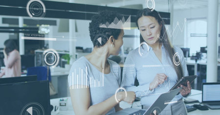 Business data analytics image over two women discussing information on tablet. collaboration,...