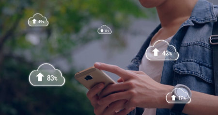 Image of clouds with growing numbers over biracial man using smartphone. Global communication,...